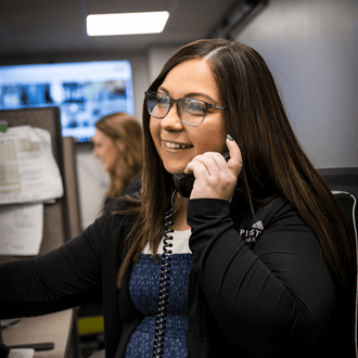 An animal health warehouse worker answers a phone call to help a farmer order product.