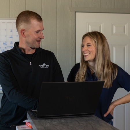 Two FarmBooks team members work together to create a financial plan for a swine producer.