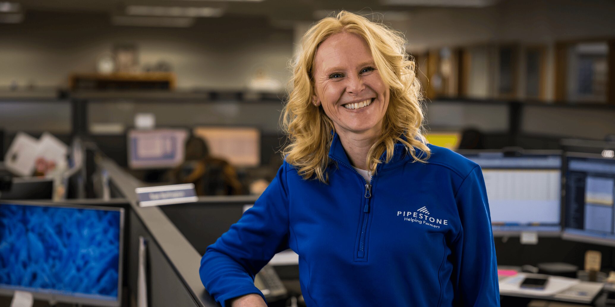 A Pipestone business team member standing in the office.