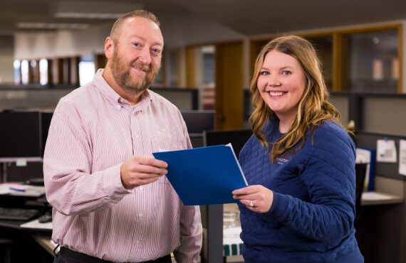 Two team members look at swine farm data.