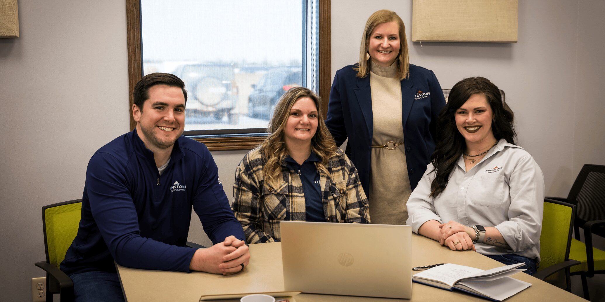 Four pipestone team members sit in a meeting room with order data in front of them on the computer.
