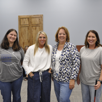 Four team members pose for a photo.